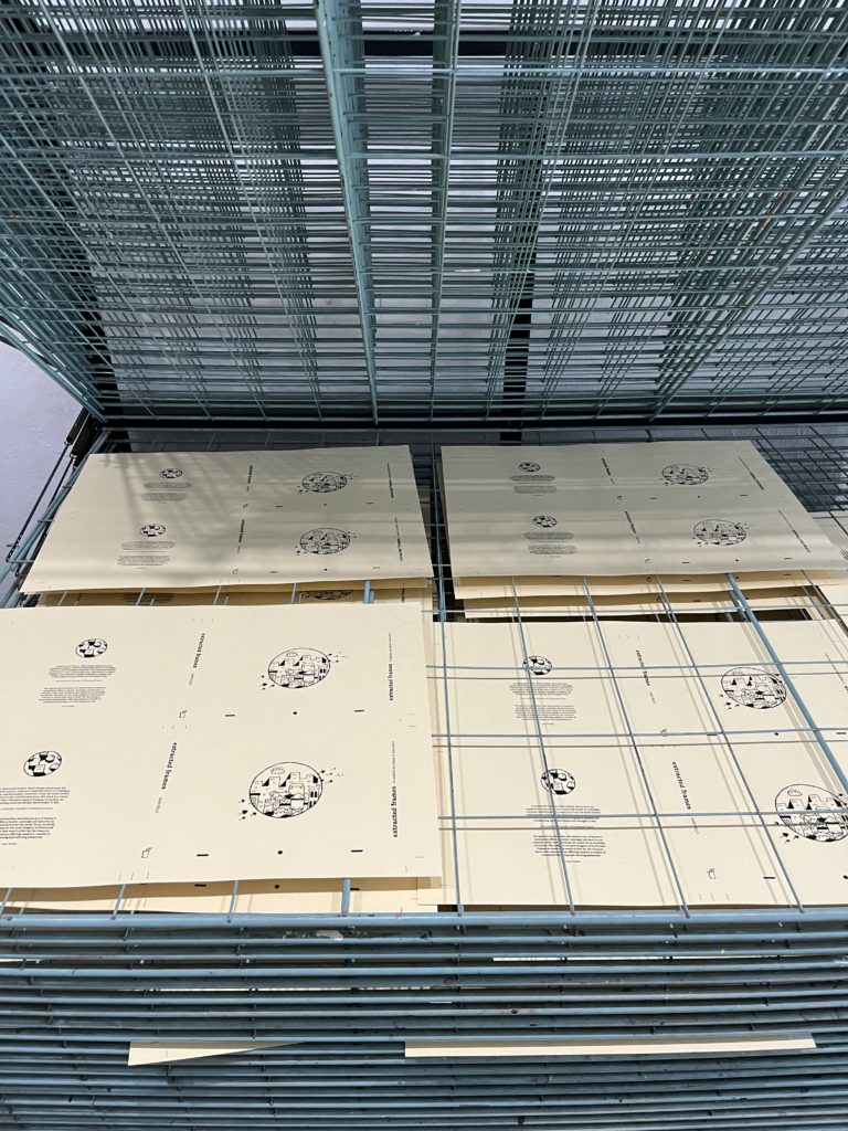 pages from "Extracted Frames" drying on a printer's rack